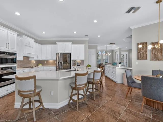 Kitchen with open floor plan, dishwasher, light countertops, and a sink