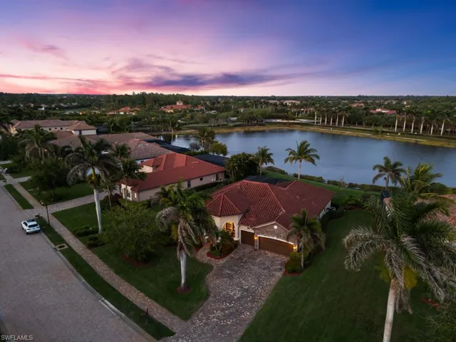 Birds eye view of property with a water view