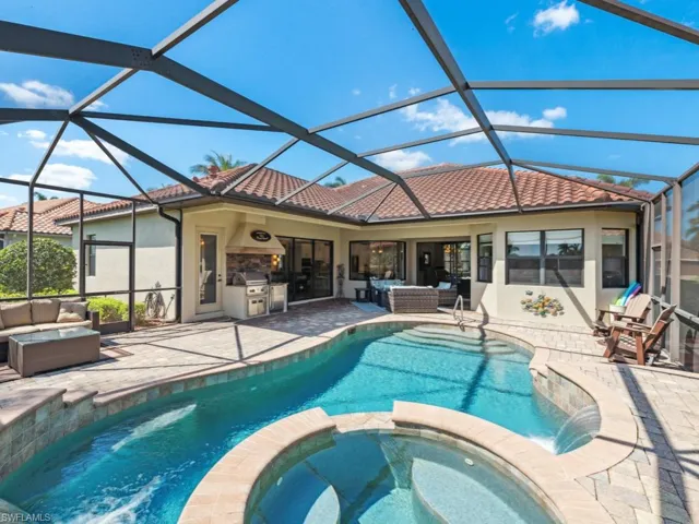 View of pool with a patio, an outdoor living space, area for grilling, and a pool with connected hot tub