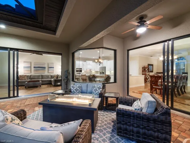 View of patio / terrace featuring ceiling fan, outdoor dining space, and an outdoor living space with a fire pit