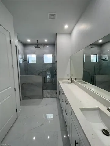 Bathroom featuring vanity and an enclosed shower