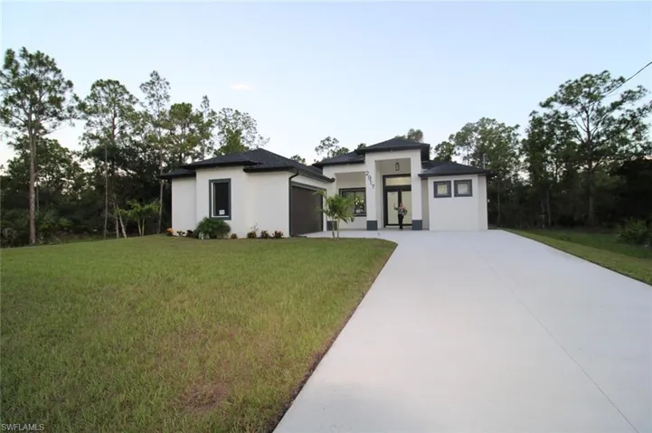 Prairie-style house featuring a garage and a front yard