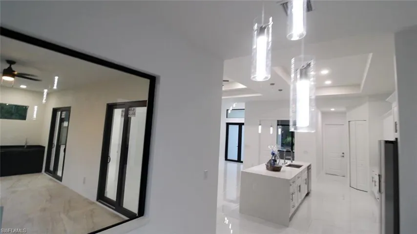 Kitchen featuring white cabinetry, a raised ceiling, and a kitchen island