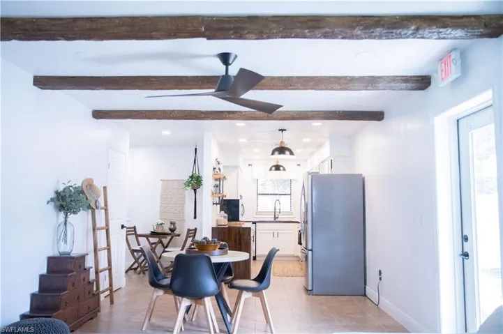 Dining area featuring recessed lighting, ceiling fan, light tile patterned floors, and beam ceiling