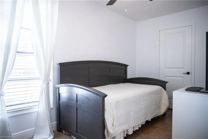Bedroom featuring a ceiling fan and dark tile patterned floors