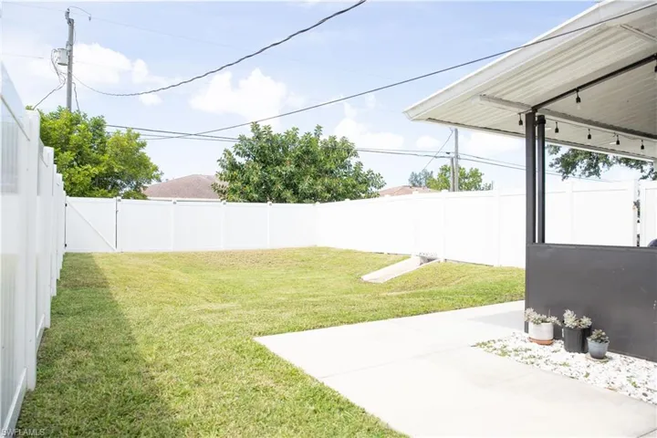 Fenced backyard with a patio