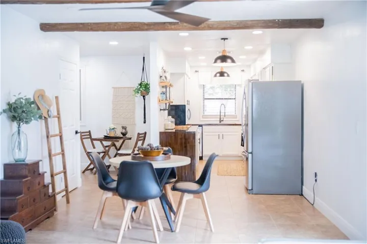 Dining area featuring recessed lighting, beamed ceiling, and light tile patterned floors