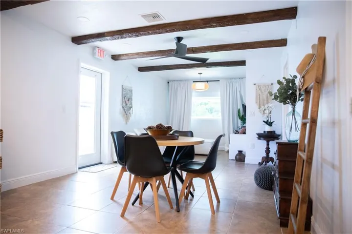 Tiled dining room with a ceiling fan, beamed ceiling, and recessed lighting