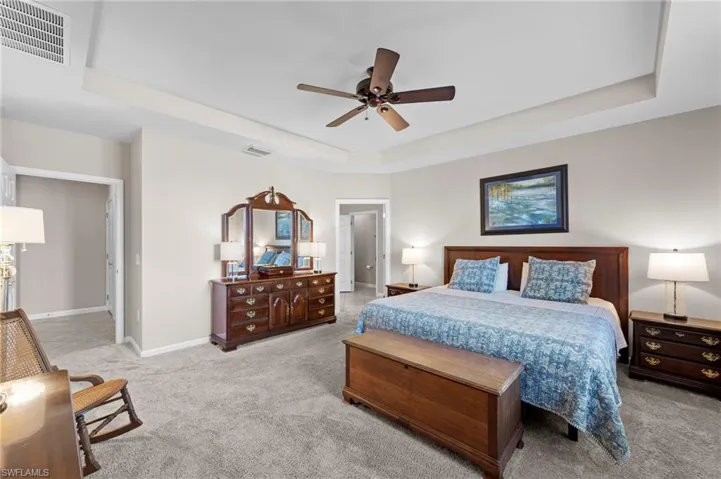Master bedroom, w/tray ceiling, door to right, leads to en-suite bath, and walk-in closet