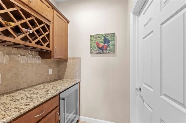 Butler pantry w/wine fridge, walk-on pantry behind door on right