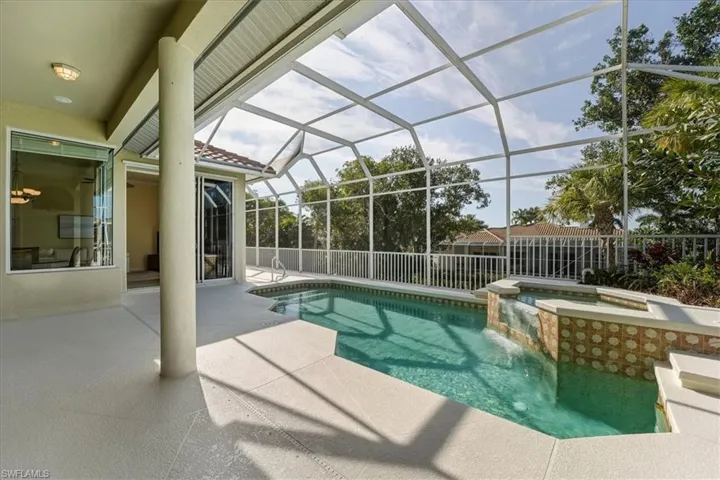 View of pool with a patio area, a lanai, a sunroom, and a pool with connected hot tub