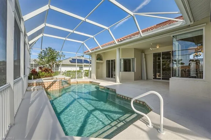 View of pool with a sunroom, a patio, a lanai, and a pool with connected hot tub