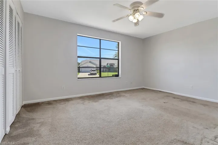 Unfurnished bedroom with carpet, a closet, and baseboards