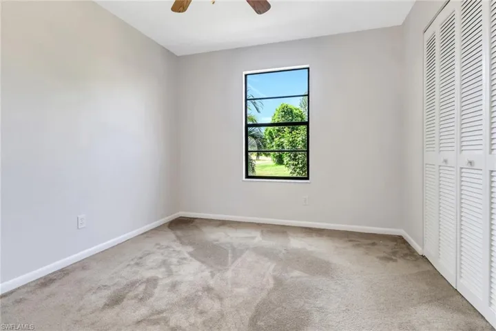 Unfurnished bedroom with a closet, ceiling fan, baseboards, and carpet floors