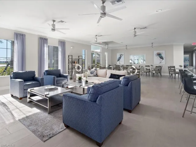 Living room with ornamental molding and light tile patterned floors