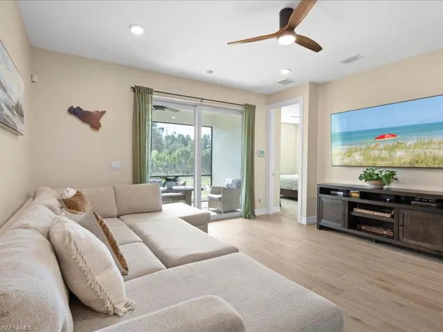 Living room featuring ceiling fan and light hardwood / wood-style flooring