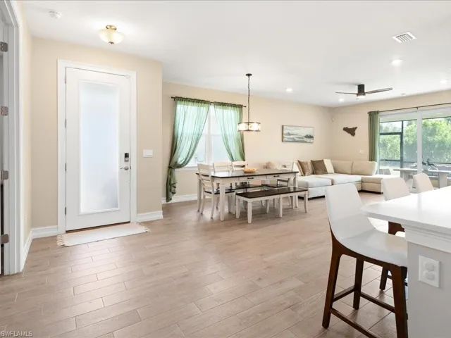 Dining room with ceiling fan and light hardwood / wood-style floors