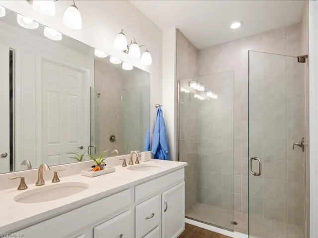 Bathroom with vanity and a shower with door