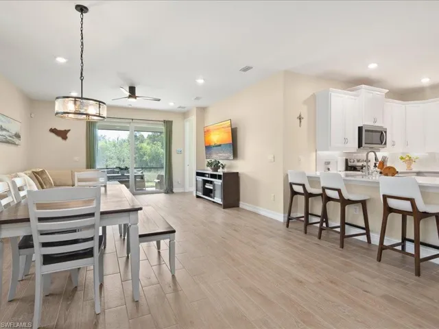 Dining room with light hardwood / wood-style flooring and ceiling fan