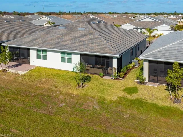 Back of property featuring a patio area, a sunroom, and a yard
