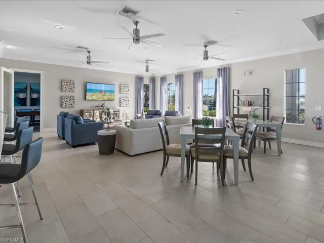 Dining space featuring ceiling fan and crown molding