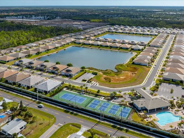 Birds eye view of property with a water view