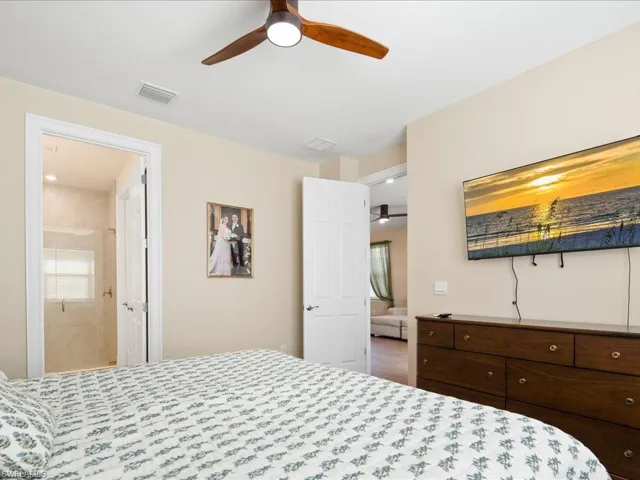 Bedroom featuring connected bathroom and ceiling fan