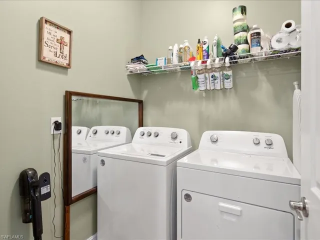 Clothes washing area featuring separate washer and dryer