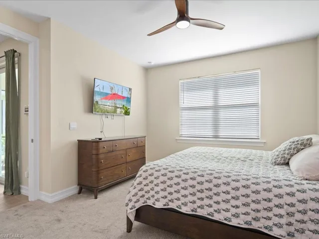 Carpeted bedroom with ceiling fan