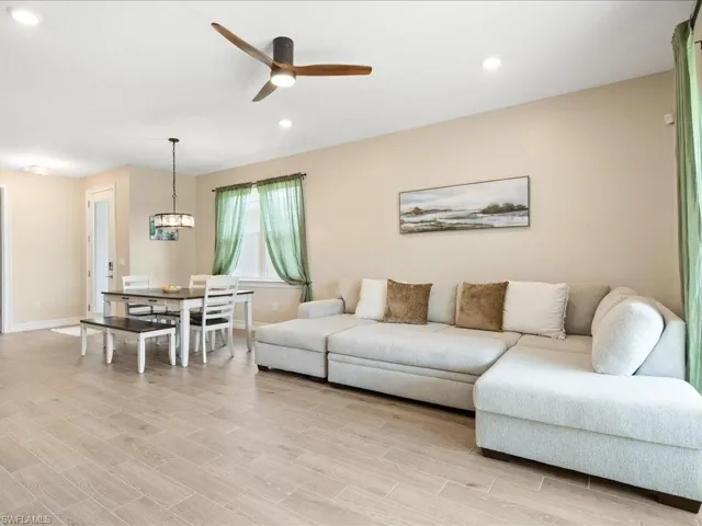 Living room featuring ceiling fan and light hardwood / wood-style floors
