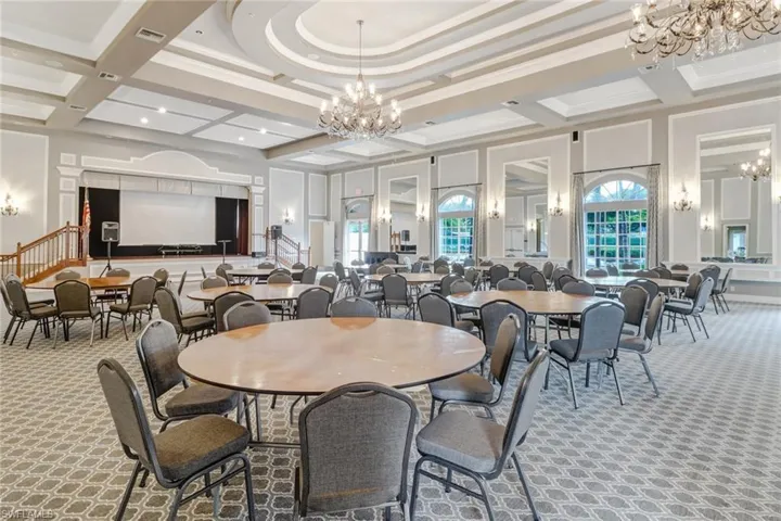 Dining area with carpet, ornamental molding, coffered ceiling, beam ceiling, and a high ceiling