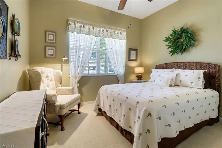 Carpeted bedroom with ceiling fan
