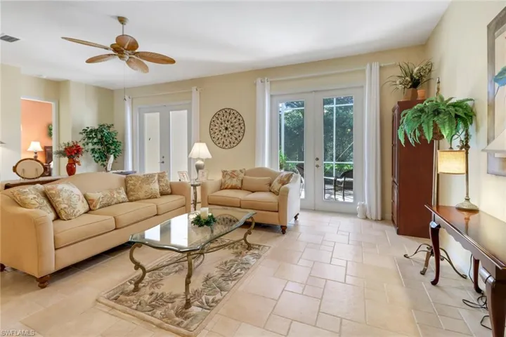 Living room with ceiling fan and french doors