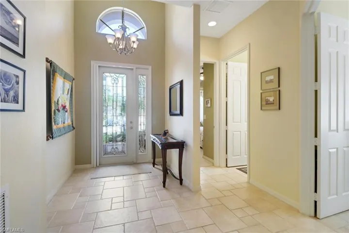 Foyer entrance with a towering ceiling and an inviting chandelier