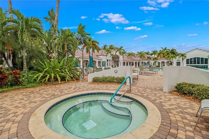 View of pool featuring a patio and a hot tub
