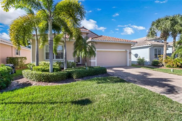 Mediterranean / spanish house featuring a front lawn and a garage