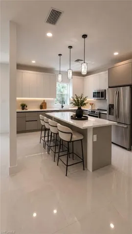 (AI Staged) Modern kitchen featuring a large central island with seating, stainless steel appliances, and sleek cabinetry