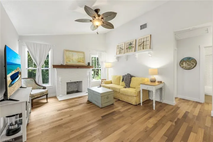 Great room features vaulted ceilings and a wood burning fireplace.