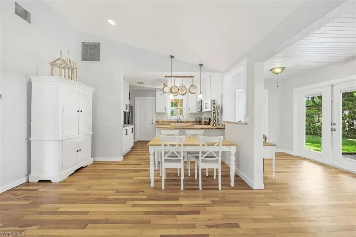 View of the kitchen from the living room. Notice the wood flooring throughout.