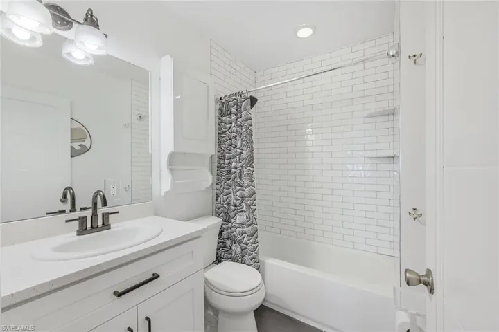 Guest bathroom features subway tile, shaker cabinets and new fixtures.