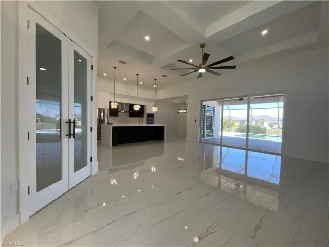 Expansive living area with large format tile flooring, a modern ceiling fan, and recessed lighting