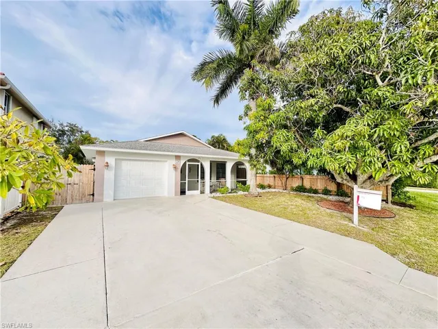 Ranch-style home with a garage, stucco siding, and concrete driveway
