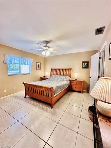 Bedroom featuring light tile patterned floors and ceiling fan