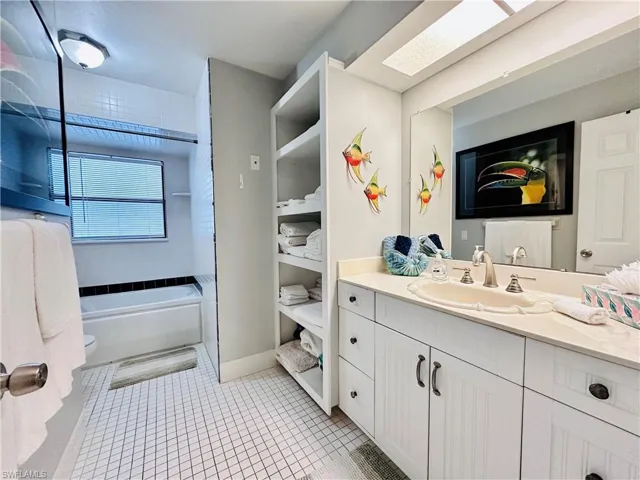 Full bathroom featuring vanity, light tile patterned flooring, and bathtub / shower combination