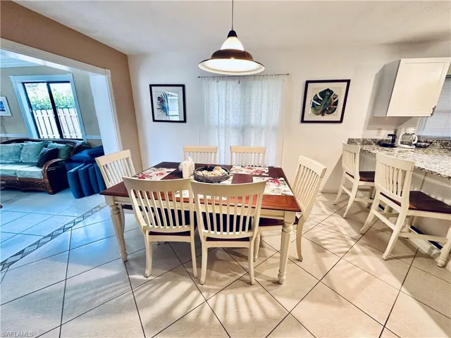 Dining space featuring light tile patterned floors