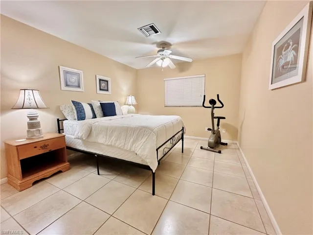 Bedroom featuring light tile patterned floors and ceiling fan