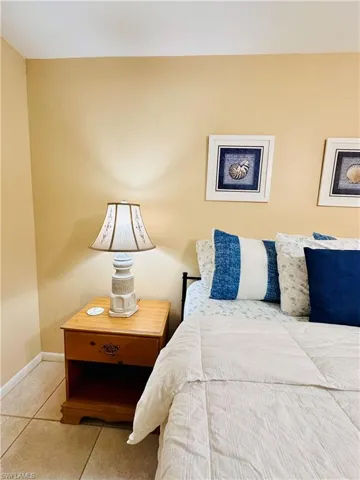 Tiled bedroom featuring baseboards