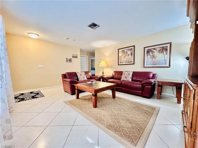 Living room featuring light tile patterned floors and baseboards
