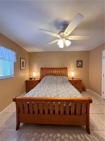 Bedroom featuring light tile patterned floors and a ceiling fan