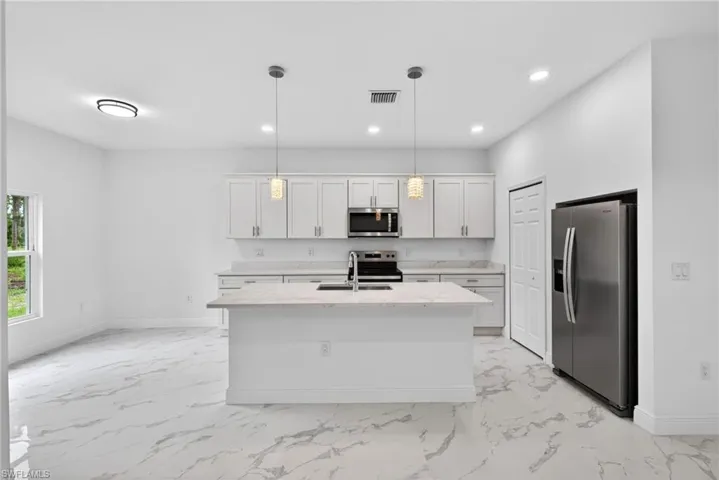 Sleek lighting and modern stainless steel appliances